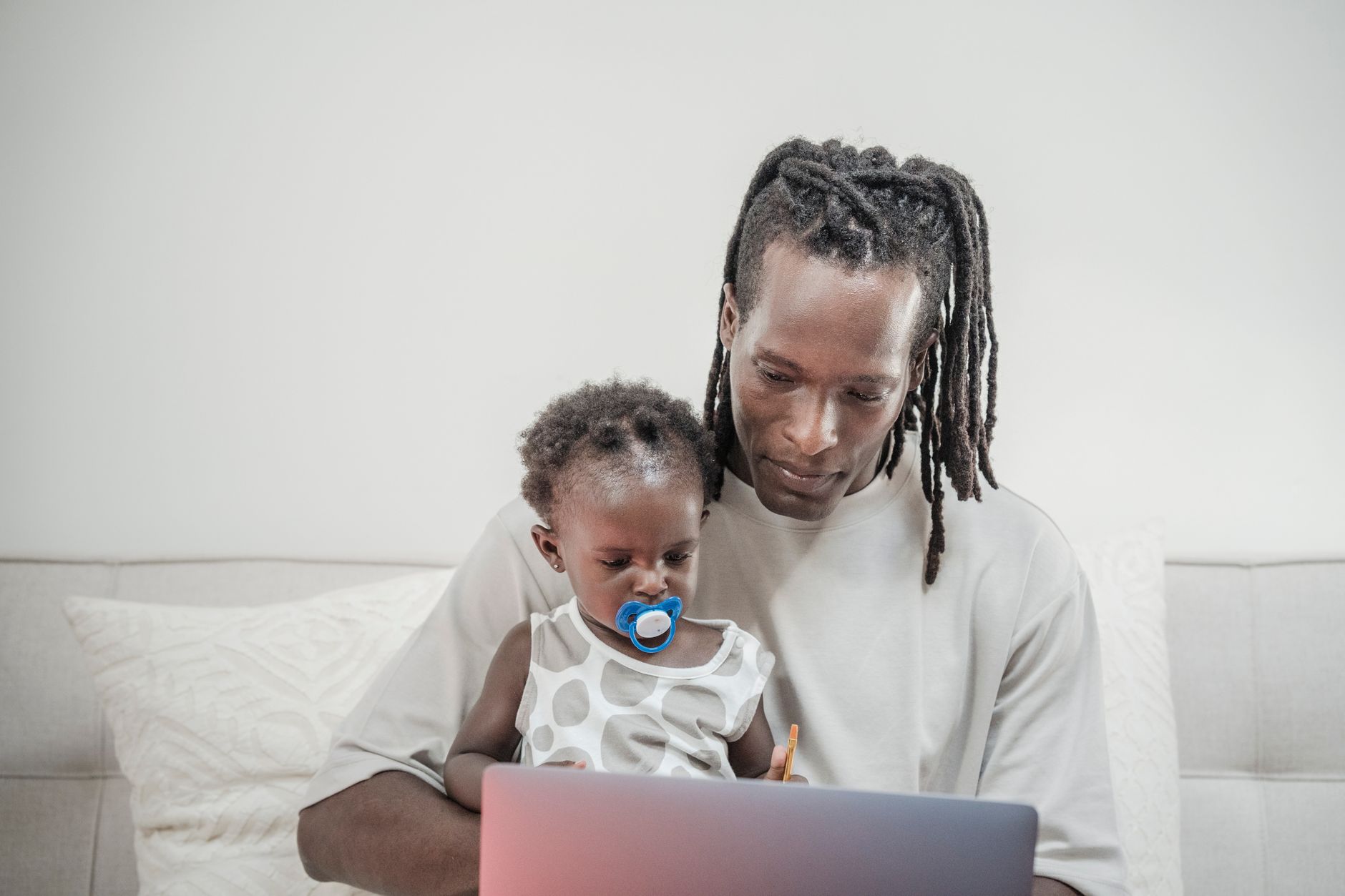A father and daughter bonding while using a laptop at home, creating precious memories — illustrating: Which cloud backup service I'd trust with my family's irreplaceable photos