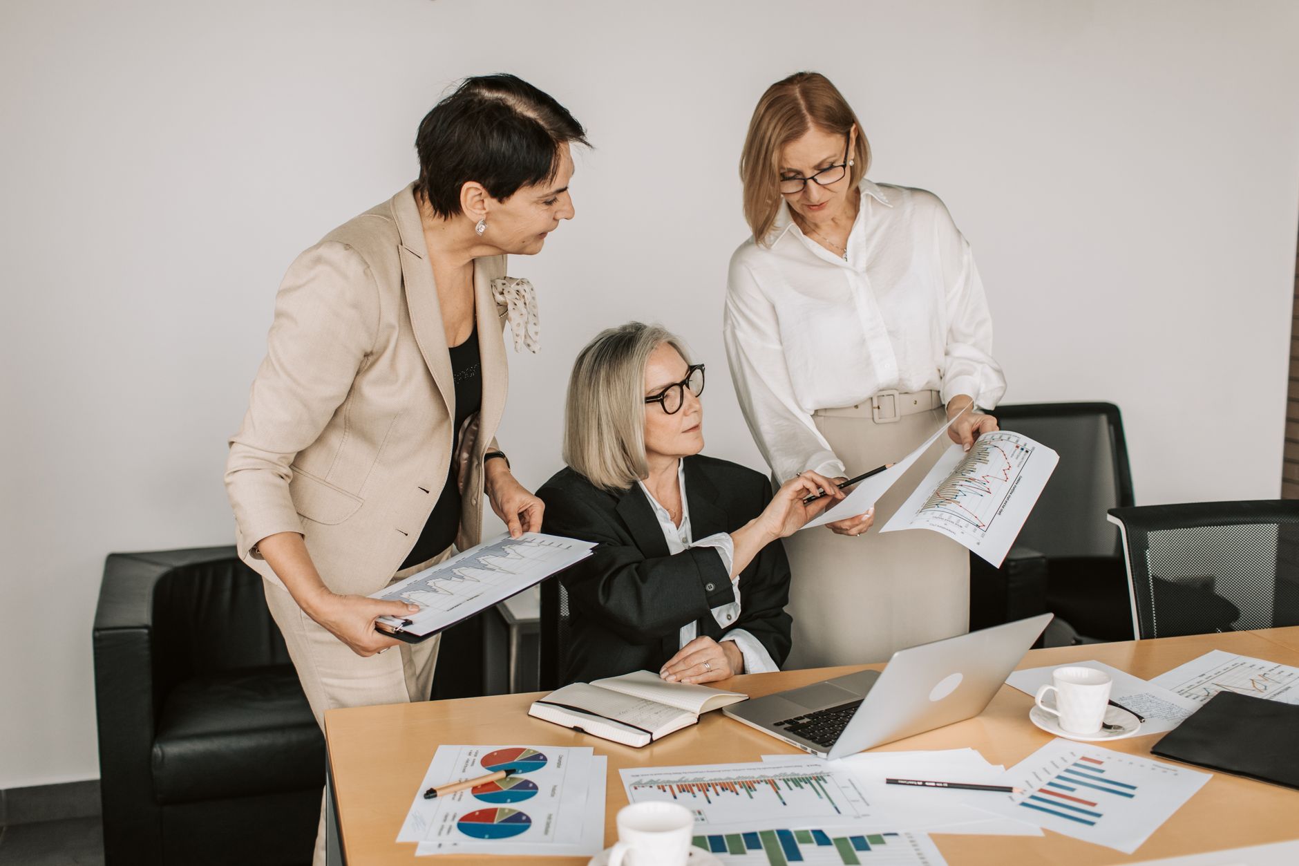 Group of senior businesswomen discussing financial charts during a formal meeting — illustrating: File backup solutions for families: what the reviews actually say and which one I'd pick